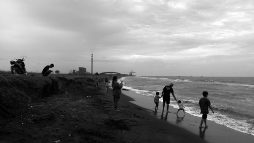 Warga desa bermain di pantai area eks proyek PLTU Indramayu 2 Desa Mekarsari, Kecamatan Patrol, Indramayu, yang airnya tercemar limbah PLTU batubara Indramayu 1, 22 Desember 2024. (Foto: Prima Mulia/BandungBergerak)