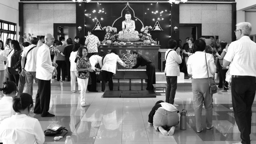 Jemaat Vihara Vimala Dharma sedang berdoa dan berinteraksi setelah ibadah Trisuci Waisak selesai di aula Bhaktisala Vihara Vimala Dharma, Bandung, Senin, 12 Mei 2025. (Foto: Abdullah Dienullah/BandungBergerak)