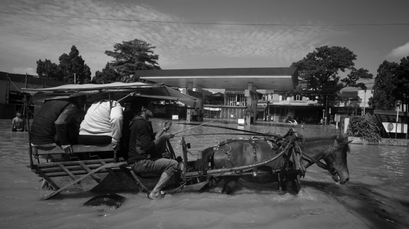 Warga menembus banjir dengan delman di Bandung Selatan, Jawa Barat, 5 Desember 2025. (Foto: Prima Mulia/BandungBergerak)