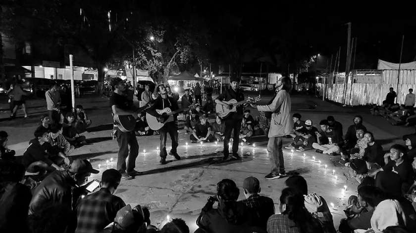 Empat musisi memainkan gitar pada Malam Nyanyian untuk Pedagang Pasar Banjaran, di Alun-Alun Banjaran, Kamis (15/6/2023). (Foto: Awla Rajul/BandungBergerak.id)