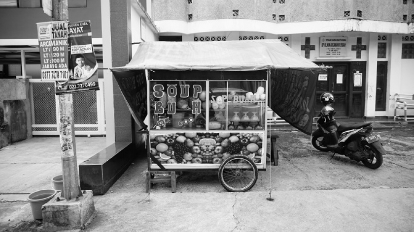 Suasana kedai sop buah kaki lima  yang dikelola Desi Kharisma di kawasan Perluasan,Arcamanik, Bandung, tepat di halaman sebuah tempat praktik dokter umum. (Foto: Bani Hakiki)