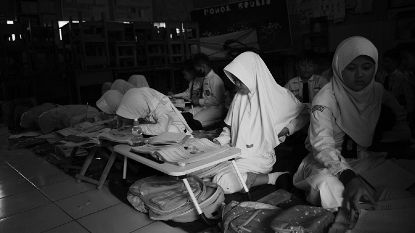 Murid SDN Leuwibandung 1 belajar di lantai karena sebagian meja kursi rusak pascabanjir, Kecamatan Dayeuhkolot, 15 Januari 2024. (Foto: Prima Mulia/BandungBergerak.id) 